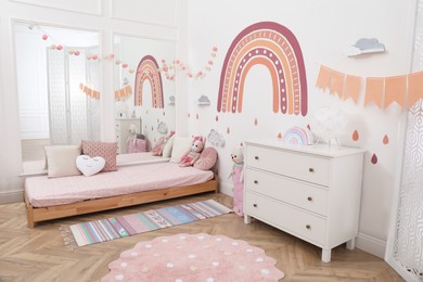 Photo of Montessori bedroom interior with floor bed and toys