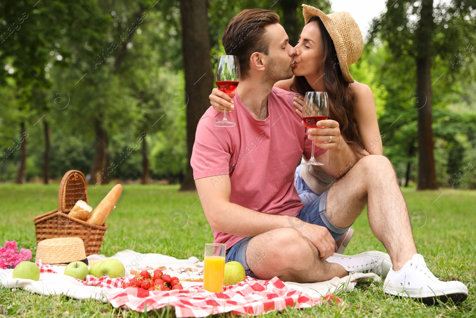 Photo of Happy young couple having picnic in park on summer day