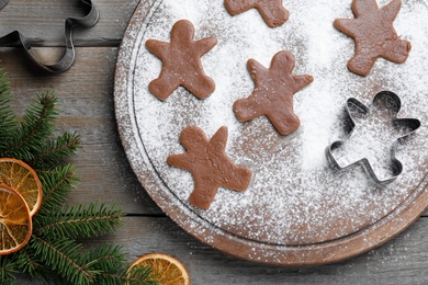 Flat lay composition with homemade gingerbread man cookies on wooden table