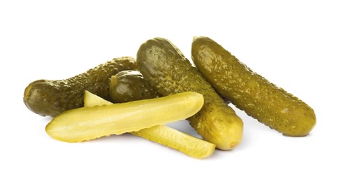 Tasty cut and whole pickled cucumbers on white background