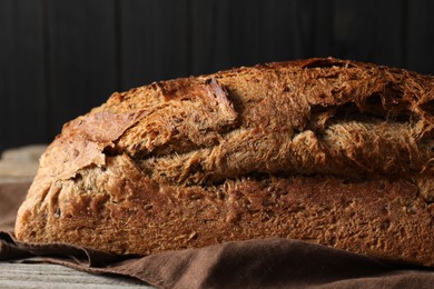 Freshly baked sourdough bread on wooden table, closeup