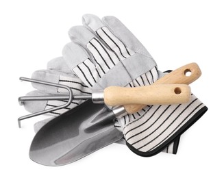 Gardening gloves, trowel and rake isolated on white, top view
