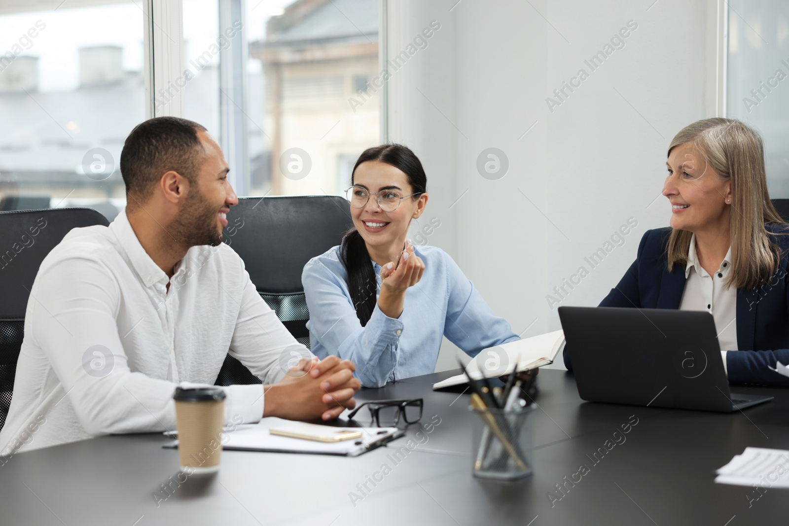 Photo of Lawyers working together at table in office