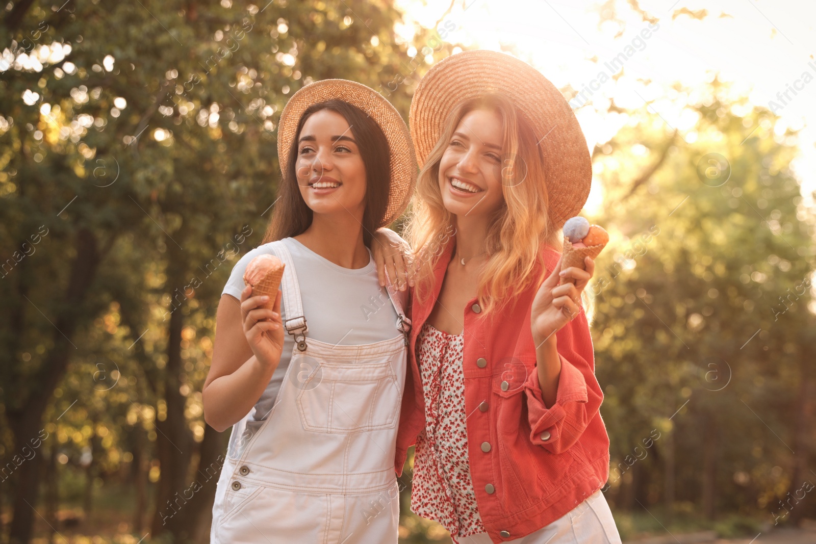 Photo of Young women with ice cream spending time together outdoors