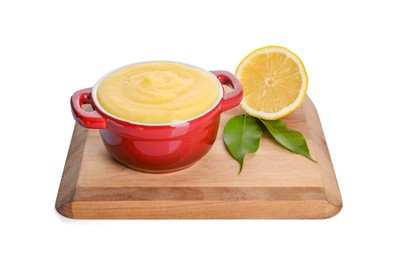 Photo of Delicious lemon curd in bowl, fresh citrus fruit and green leaves isolated on white