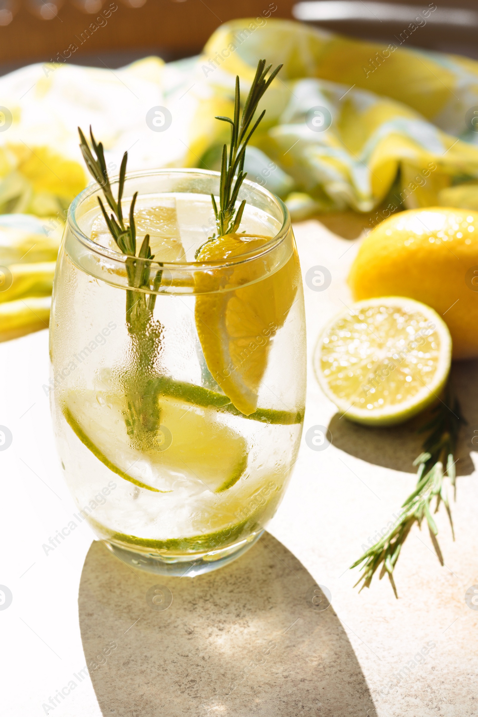 Photo of Tasty refreshing lemonade and ingredients on light table. Summer drink