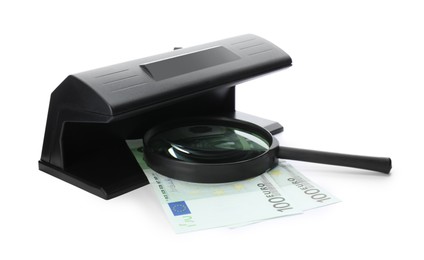 Modern currency detector with Euro banknotes and magnifying glass on white background. Money examination device