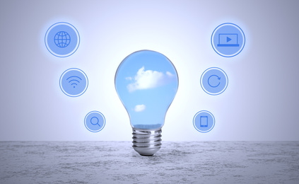 Cloud technology concept. Light bulb with sky and different icons