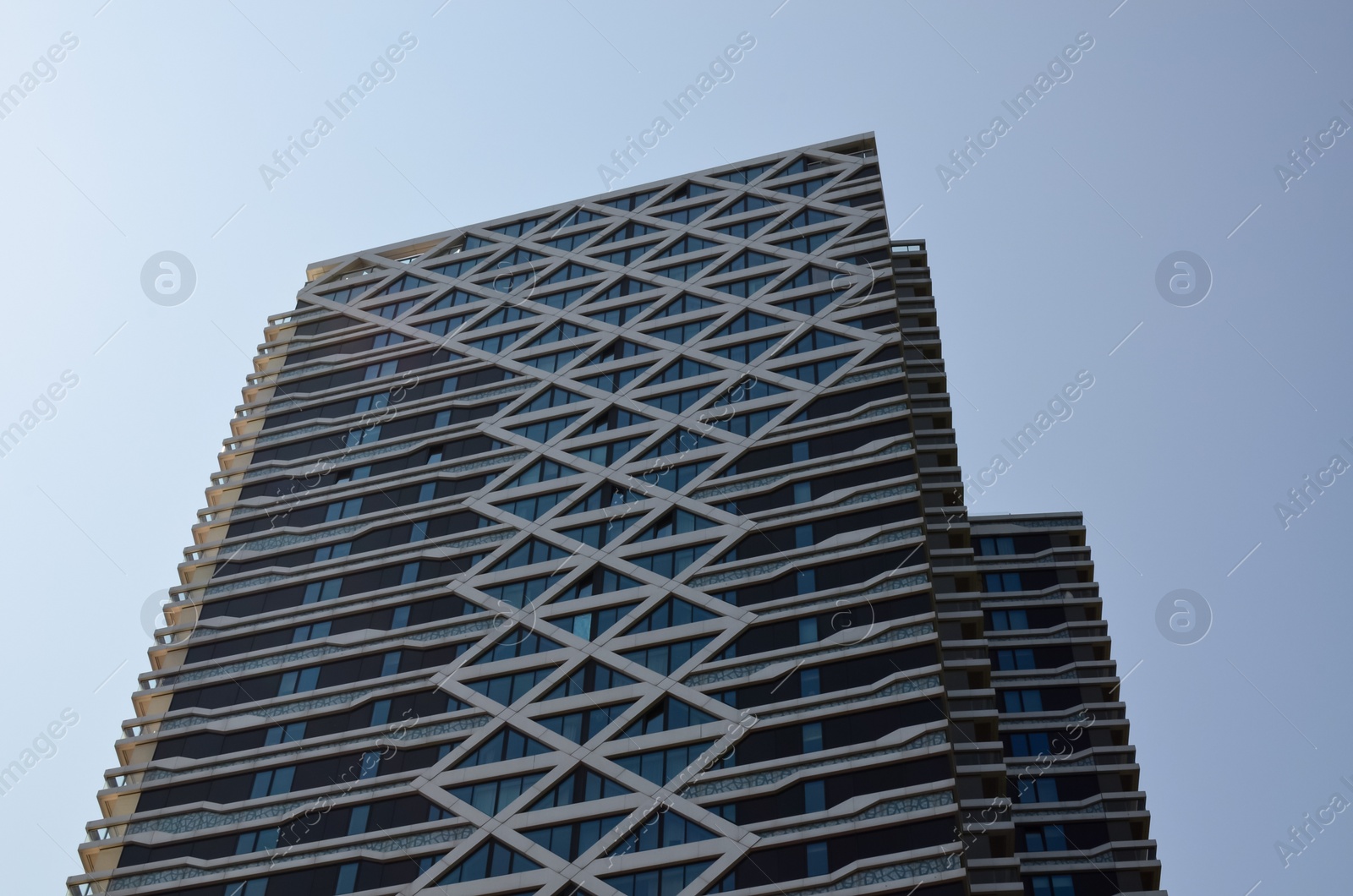 Photo of Exterior of beautiful modern building against blue sky, low angle view