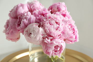 Photo of Bouquet of beautiful peonies on table indoors, closeup