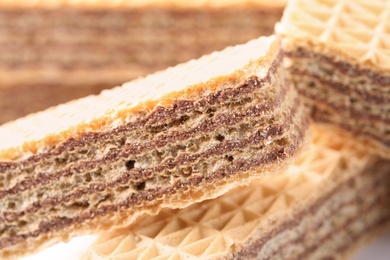 Photo of Delicious crispy wafers with chocolate filling as background, closeup