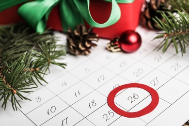 Calendar with marked Boxing Day date and fir branches, closeup