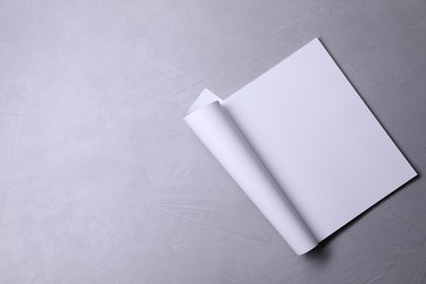 Photo of Blank paper sheet on grey textured background, top view. Mockup for design