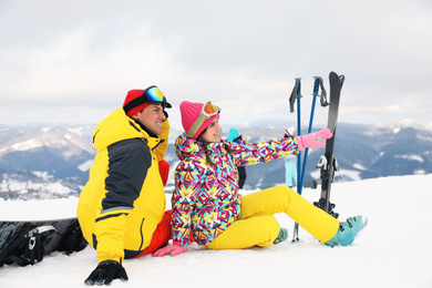 Photo of Lovely couple with equipment at ski resort. Winter vacation