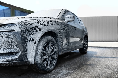 Photo of Clean auto with foam at self-service car wash