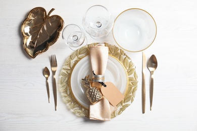 Elegant table setting on light background, top view