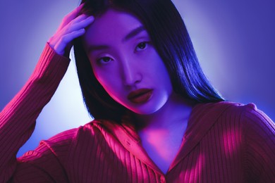 Image of Portrait of beautiful woman in neon lights