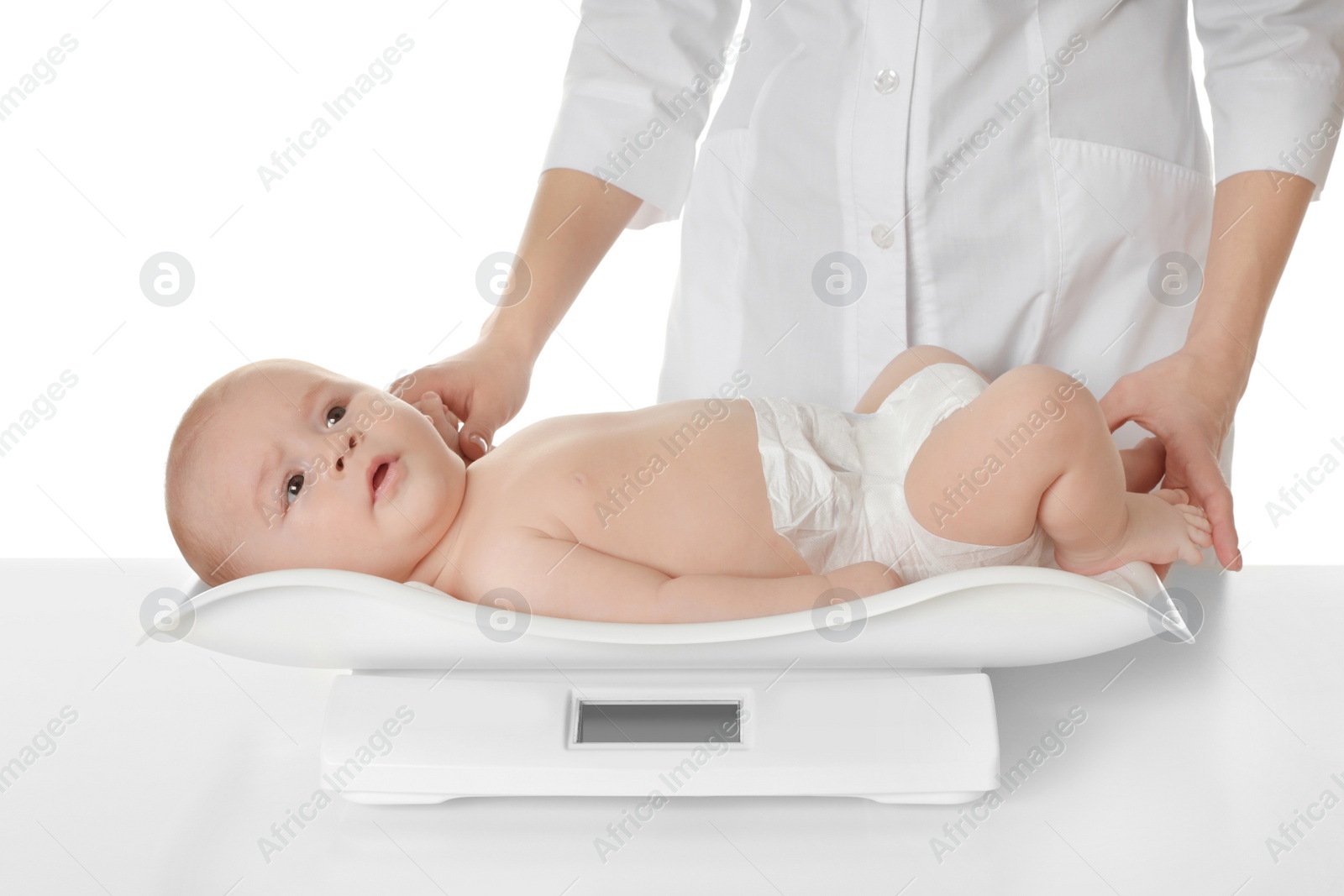 Photo of Doctor weighting baby on scales against white background