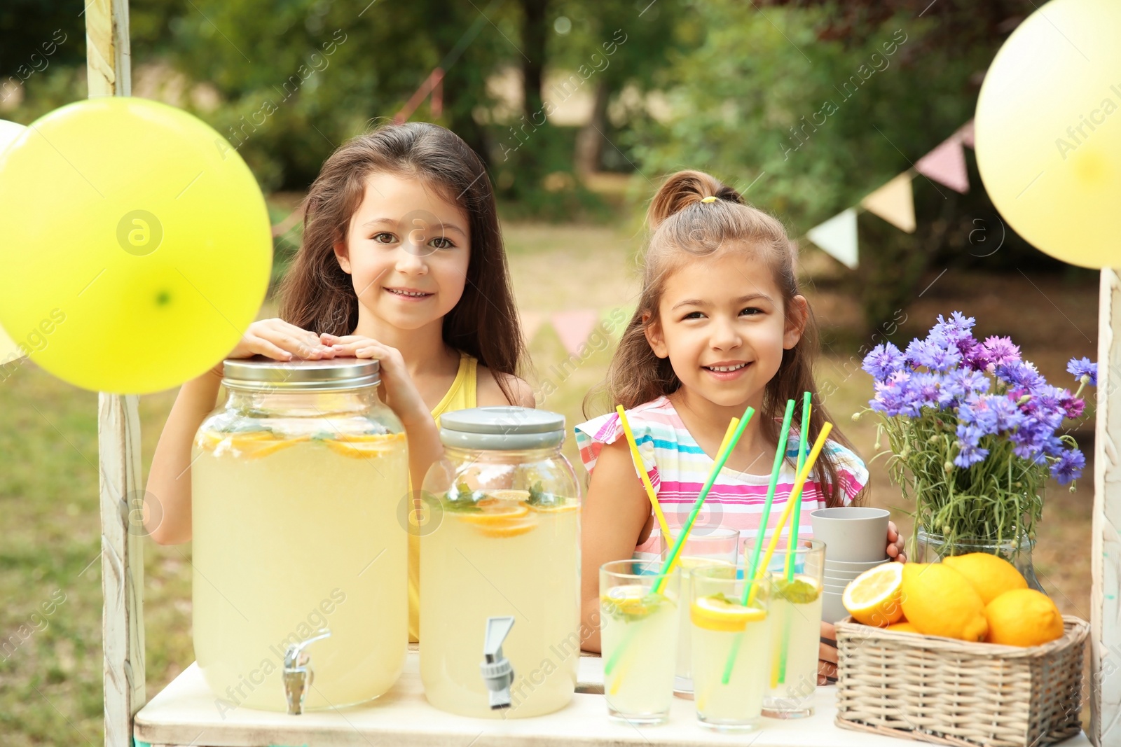 Photo of Little girls at lemonade stand in park