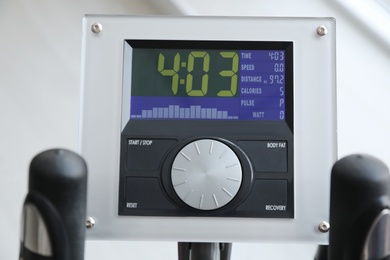 Photo of Control panel of modern elliptical machine cross trainer on blurred background