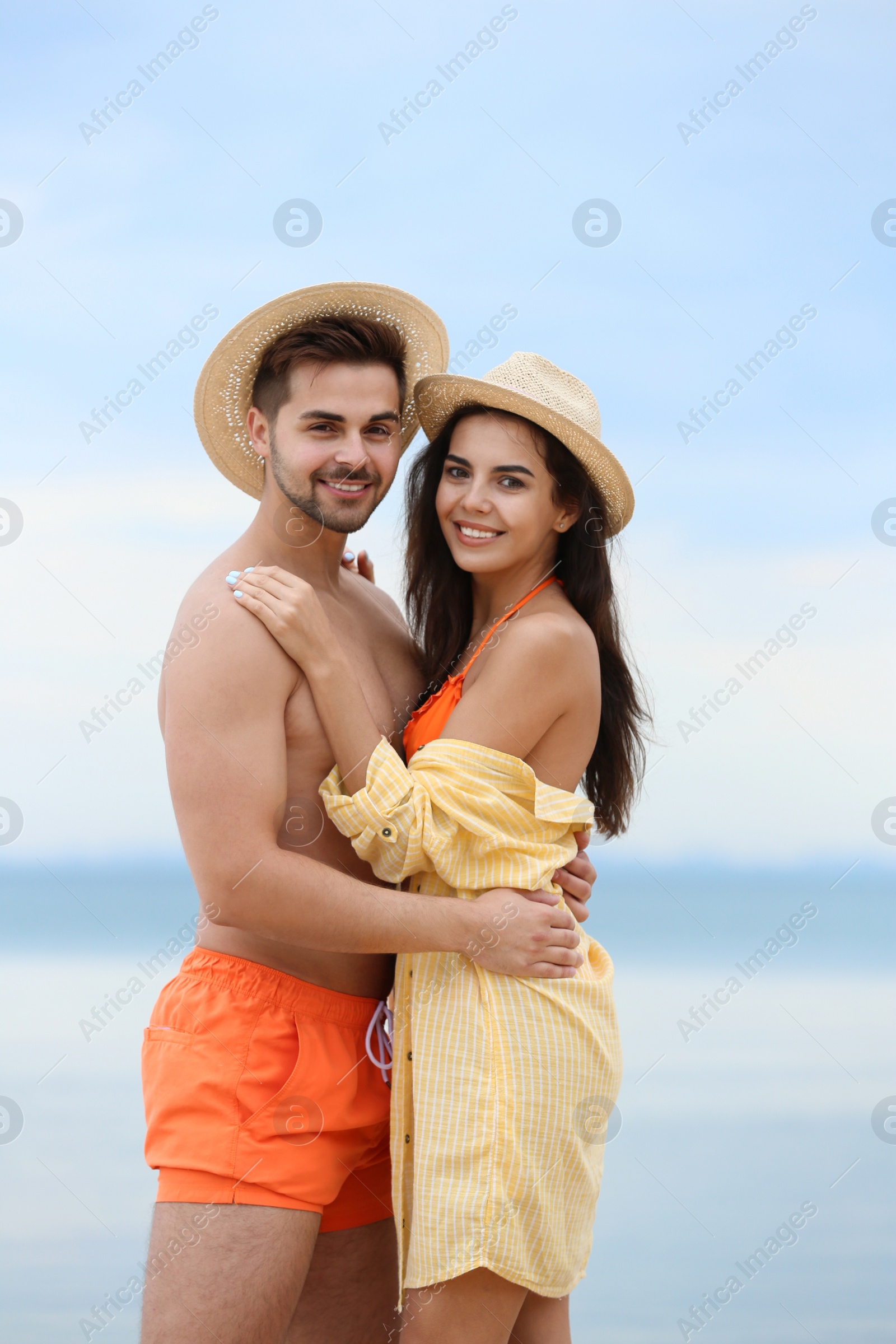 Photo of Happy young couple spending time together on beach