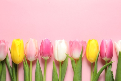 Photo of Flat lay composition of beautiful spring tulips on color background, space for text. International Women's Day