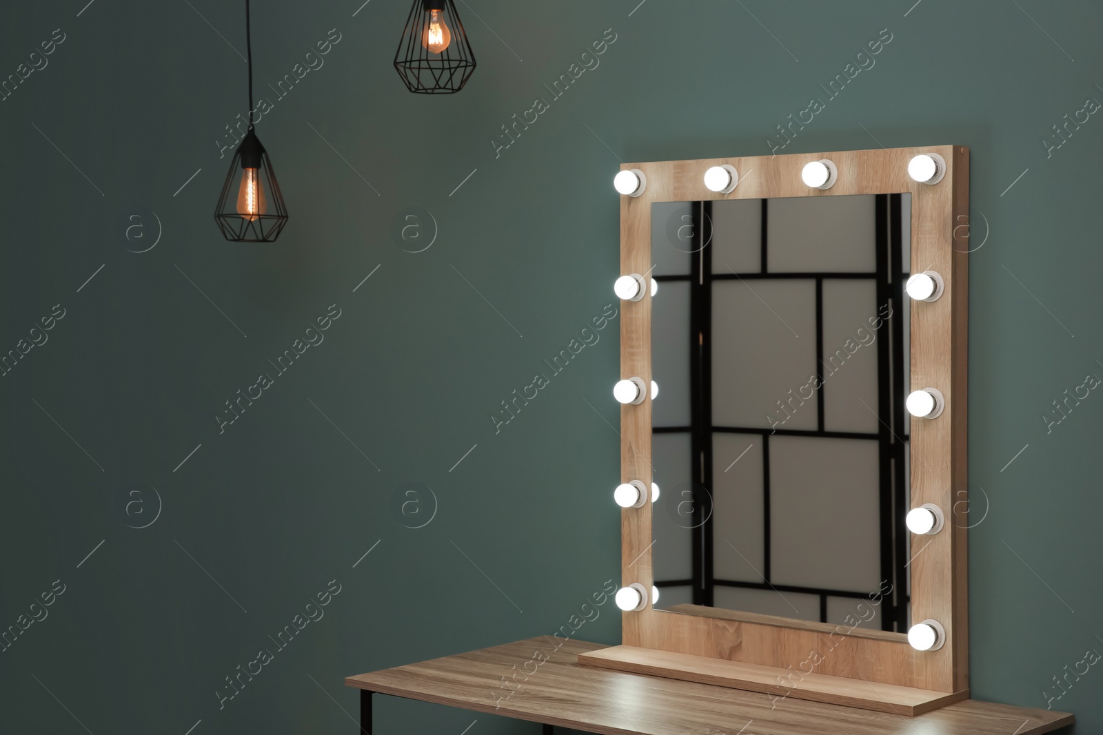 Photo of Beautiful mirror with lamps in modern makeup room
