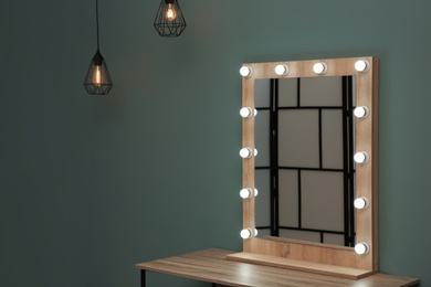 Beautiful mirror with lamps in modern makeup room