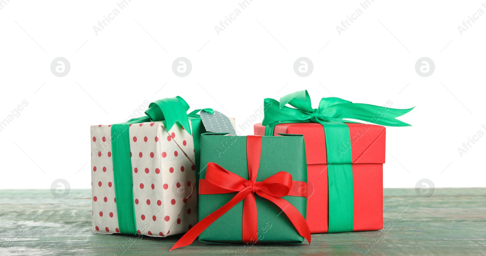 Photo of Different Christmas gifts on wooden table against white background