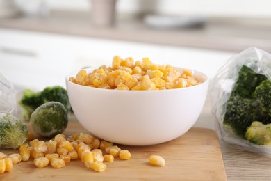 Photo of Frozen vegetables on wooden table in kitchen, closeup