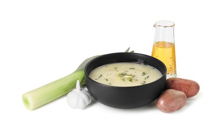 Photo of Bowl of tasty leek soup and ingredients isolated on white