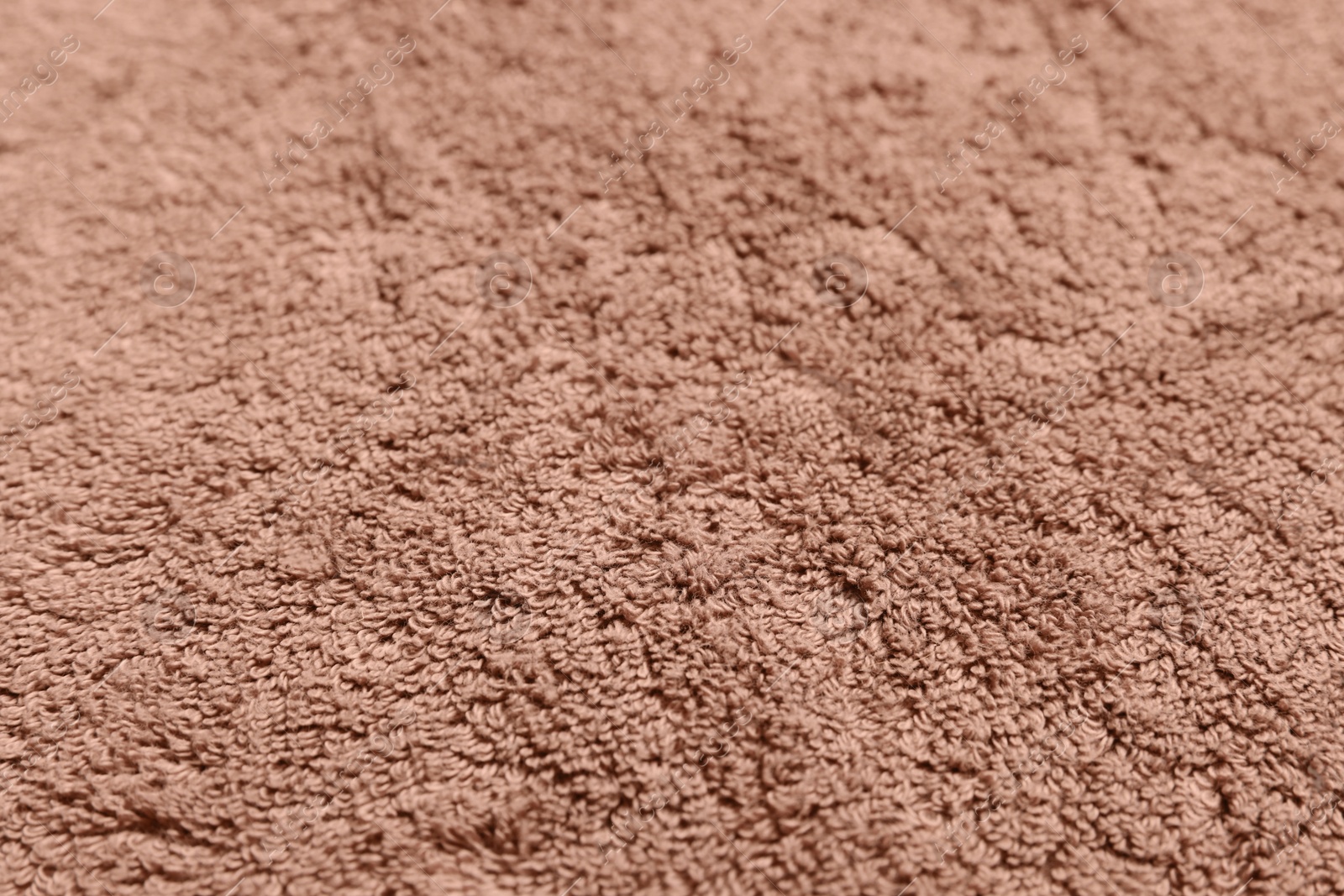 Photo of Dry soft brown towel as background, closeup