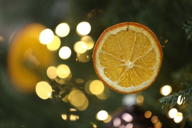 Dry orange slice hanging on Christmas tree, space for text. Handmade decor