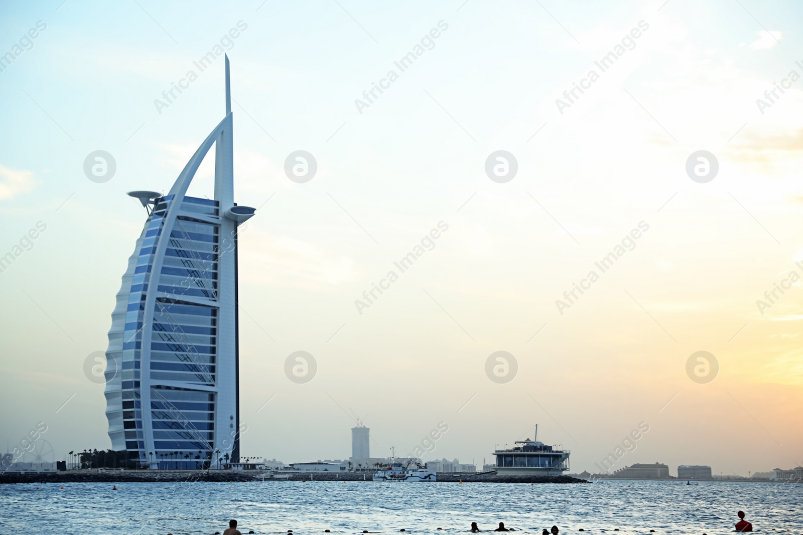 Photo of DUBAI, UNITED ARAB EMIRATES - NOVEMBER 03, 2018: Beautiful view of famous Burj Al Arab and amazing sunset sky