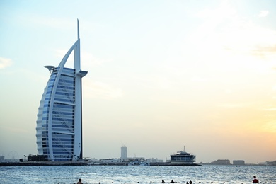 Photo of DUBAI, UNITED ARAB EMIRATES - NOVEMBER 03, 2018: Beautiful view of famous Burj Al Arab and amazing sunset sky