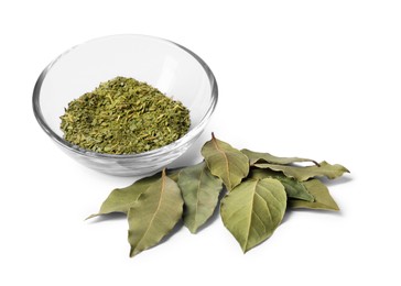 Photo of Ground and whole bay leaves on white background