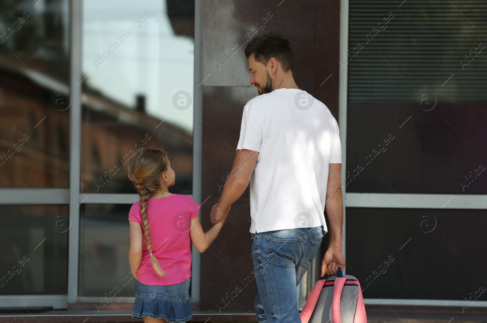 Photo of Little girl with her father on way to school