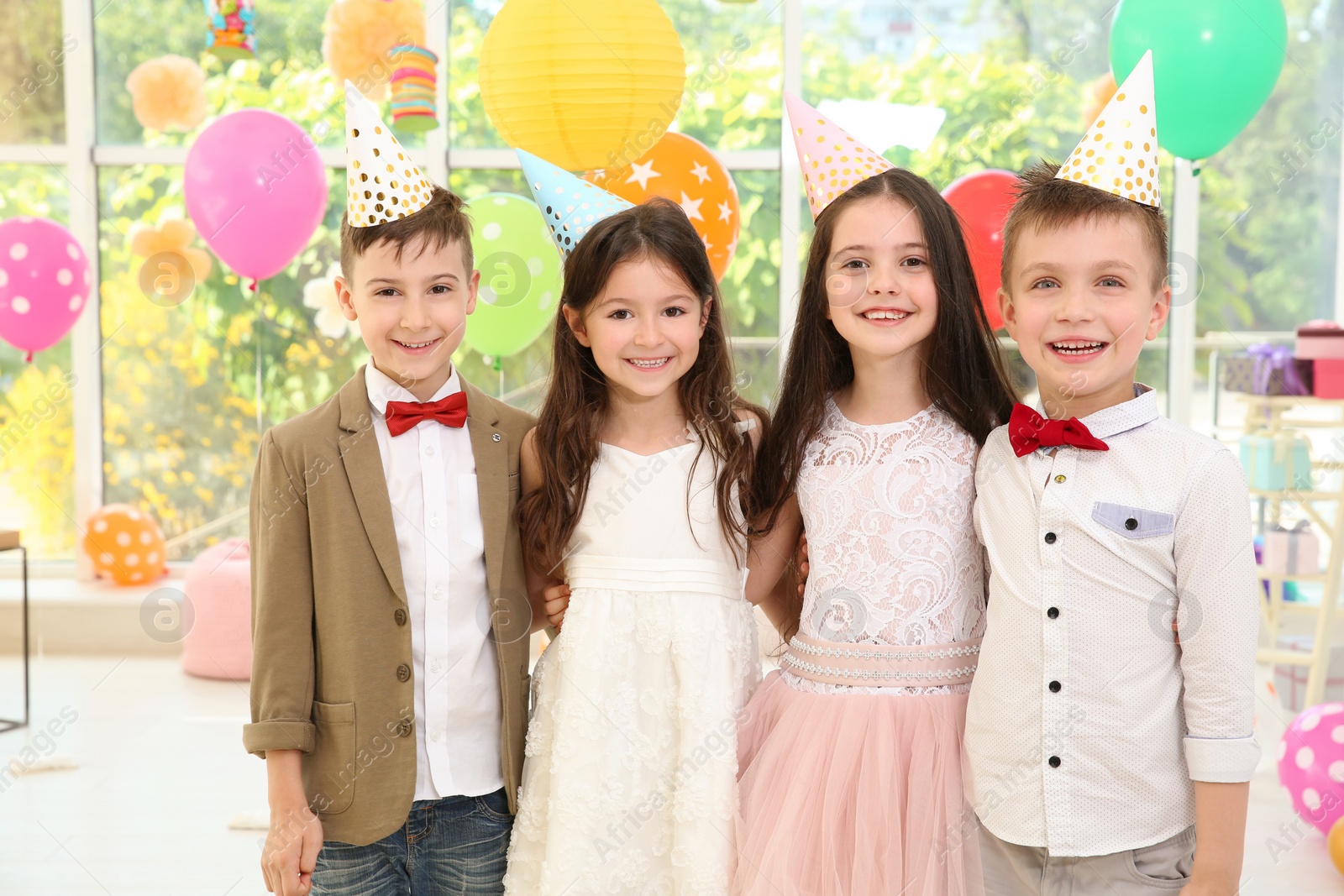 Photo of Cute little children at birthday party indoors