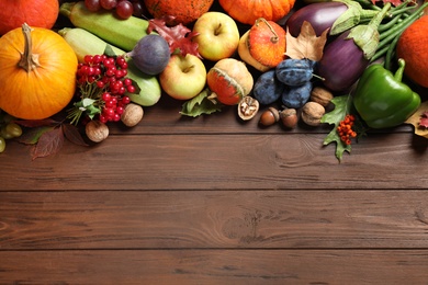 Flat lay composition with autumn vegetables and fruits on wooden background, space for text. Happy Thanksgiving day