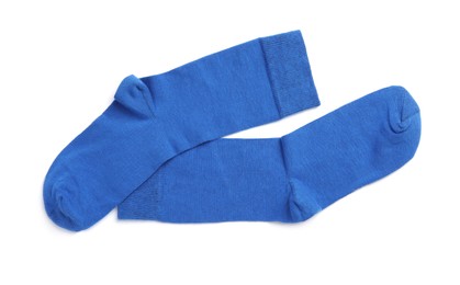 Photo of Pair of blue socks on white background, top view
