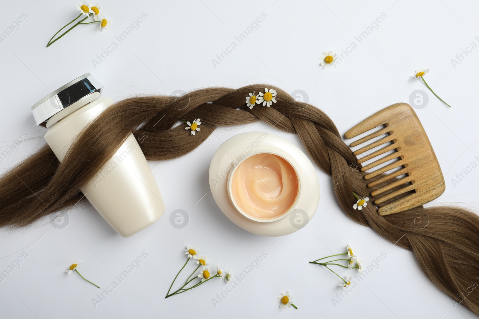 Photo of Flat lay composition with natural cosmetic products and hair braid on white background