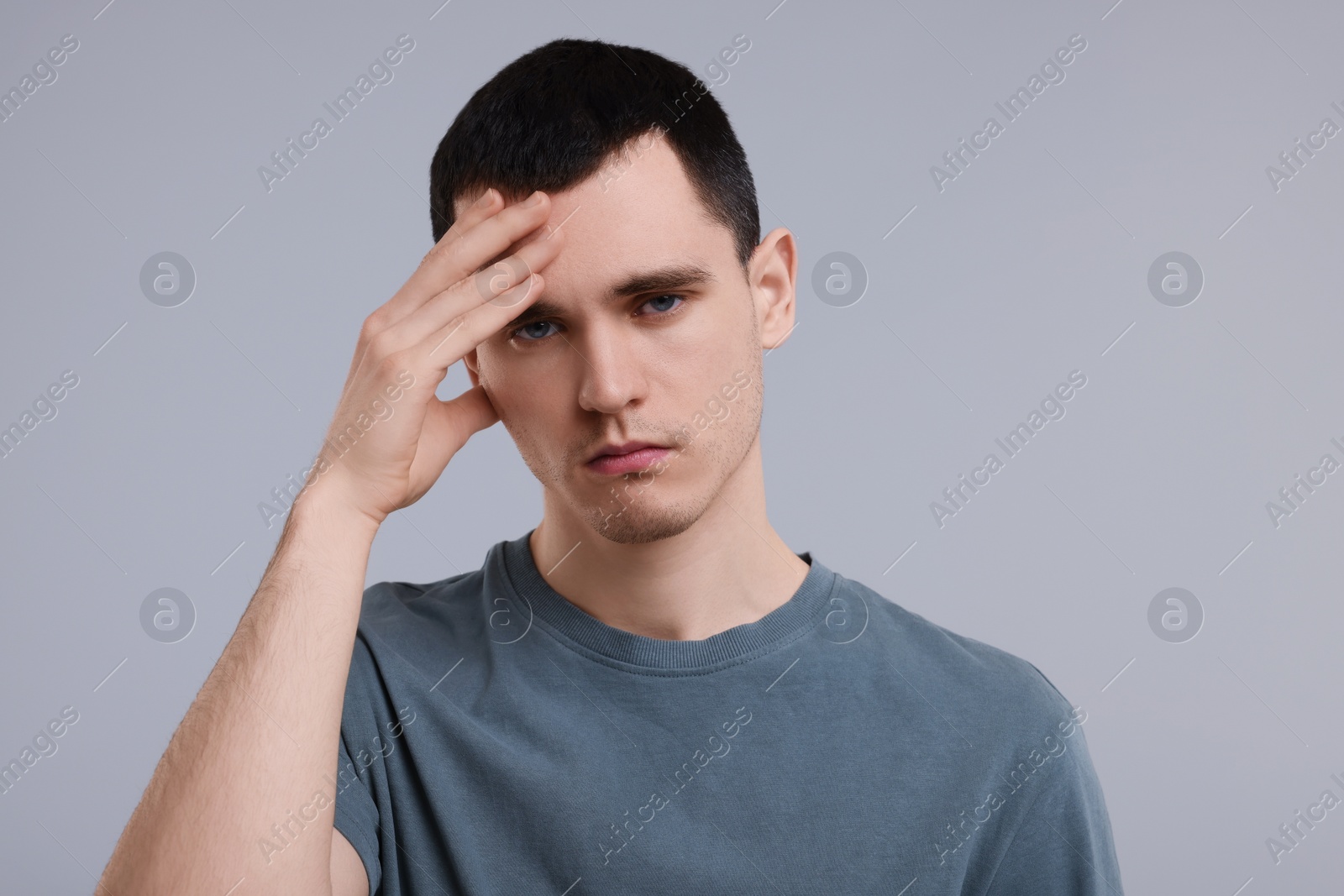 Photo of Portrait of sad man on grey background