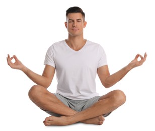 Photo of Handsome man meditating on white background. Harmony and zen