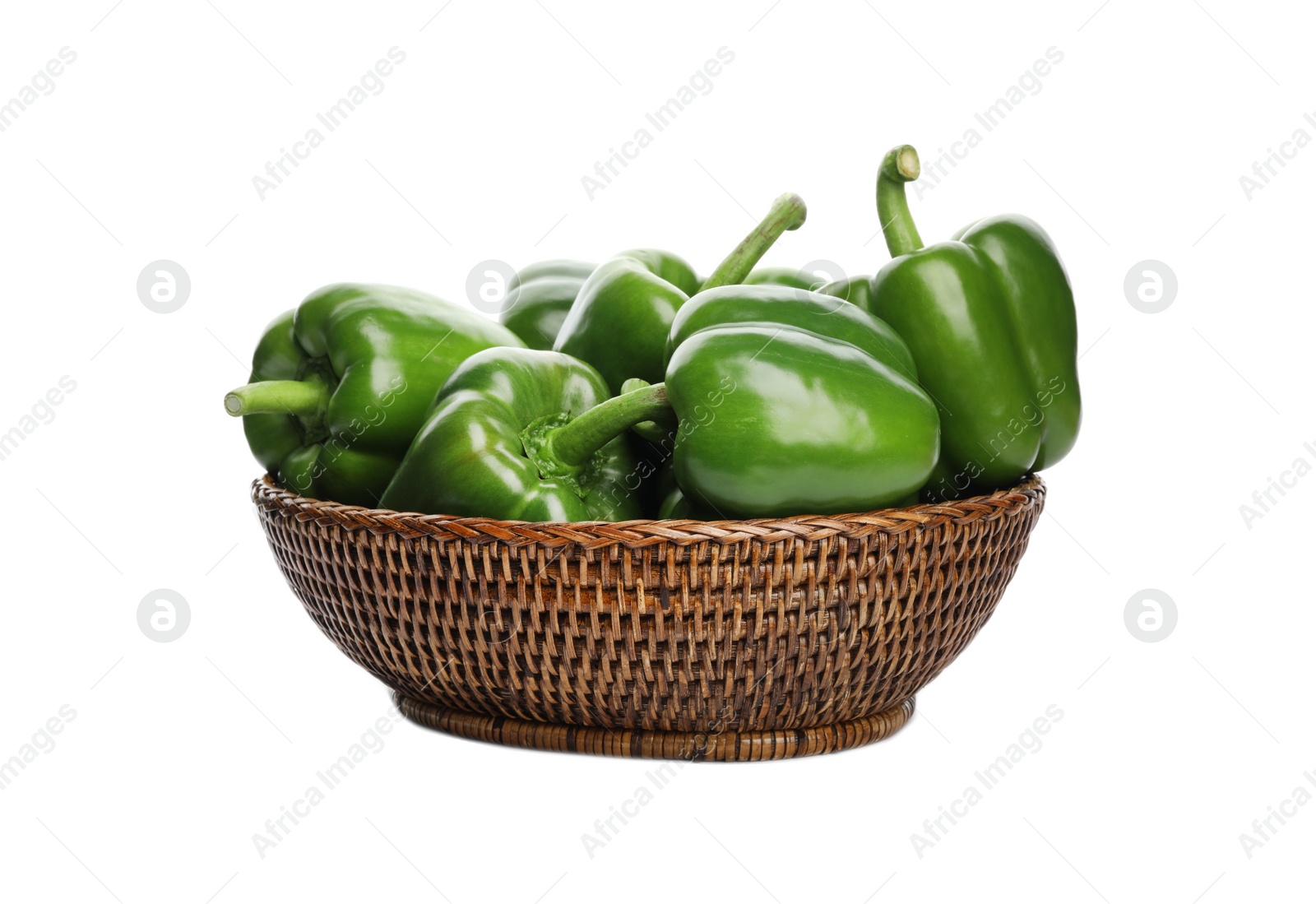 Photo of Wicker bowl with ripe green bell peppers on white background