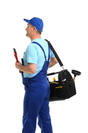 Photo of Mature plumber with pipe wrench and tool bag on white background