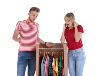 Photo of Young couple near wardrobe box on white background