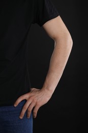 Photo of Man with space for tattoo on his arm against black background, closeup