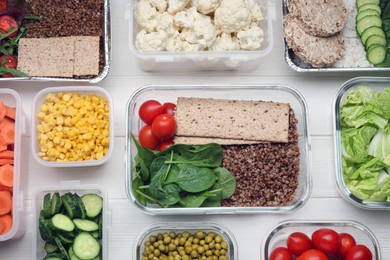 Photo of Different containers with fresh products on white wooden table, flat lay