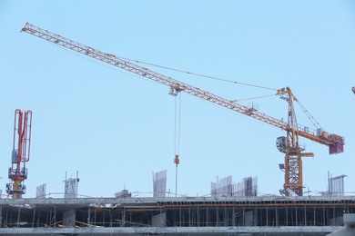 Photo of Construction crane and unfinished building, outdoors