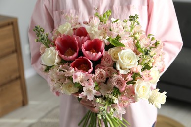 Photo of Woman with beautiful bouquet of fresh flowers indoors, closeup